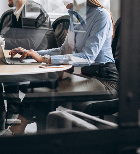 Langile taldea ordenagailu eramangarriekin bulegoko bilera batean